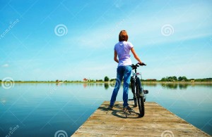 http://www.dreamstime.com/royalty-free-stock-images-young-woman-looking-horizon-standing-pier-bicycle-outdoor-shoot-image47743499